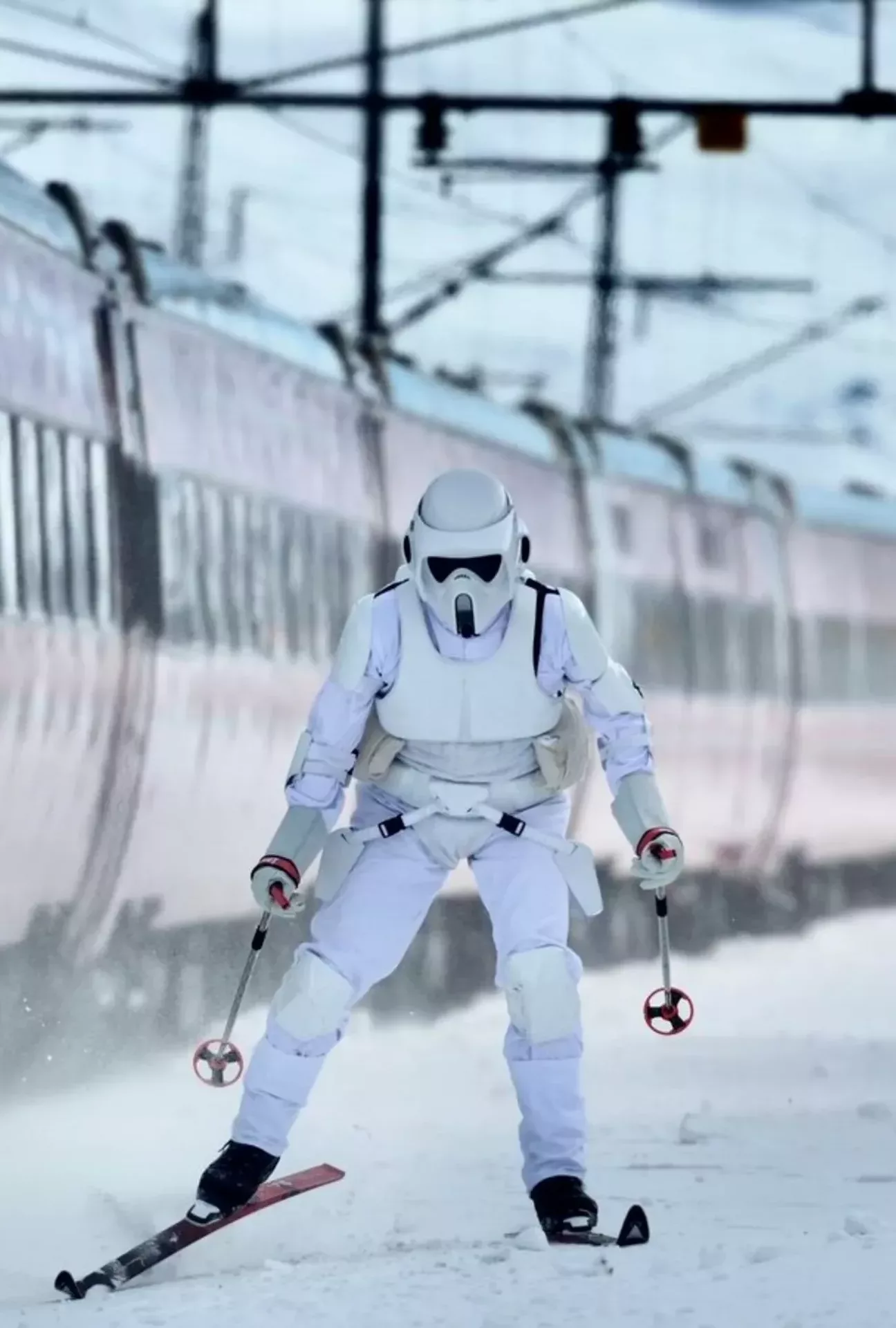 A Storm Trooper skiing next to the train at Finse train station in Norway.